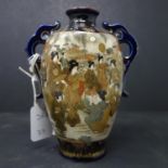A Japanese twin handle satsuma vase, decorated with vignettes of geishas and warriors, stamped to