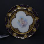 A 19th century porcelain plate, the centre hand painted with a cherub painting a portrait, within