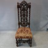 An antique Charles II style carved oak chair