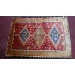 A Southwest Persian Qashqai rug, triple pole medallion with repeating petal motifs on a rouge field,