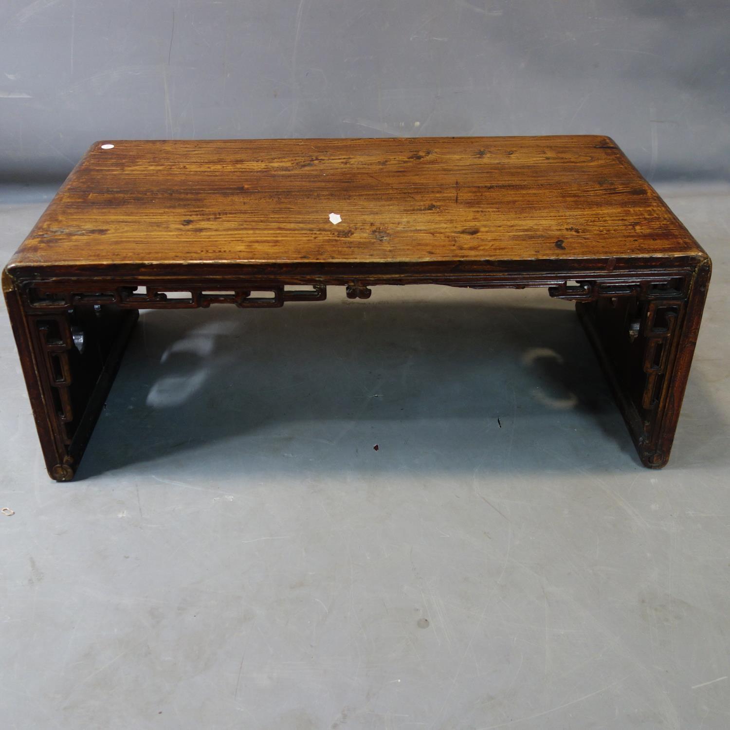 A Chinese hardwood low table, with pierced apron, H.34 W.86 D.46cm