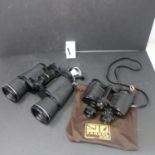 A pair of Tasco Zip 2008 10 x 50mm binoculars, together with a pair of 8 x 30 binoculars (2)