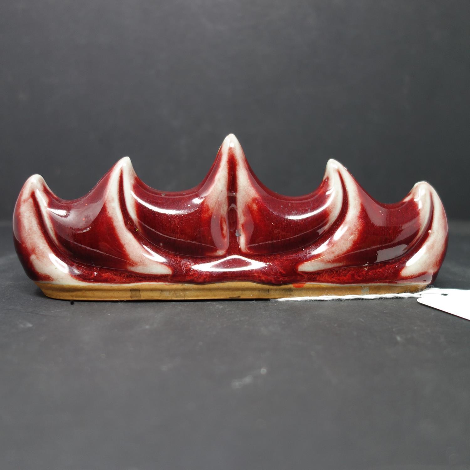 A 20th century Chinese ox blood brush rest, H.7 W.19cm