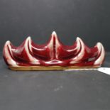 A 20th century Chinese ox blood brush rest, H.7 W.19cm