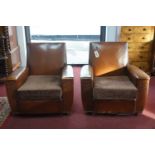 A pair of Edwardian armchairs with vinyl and leather upholstery