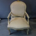 A Louis XV style cream and gilt armchair, with light pink floral upholstery, on cabriole legs, H.100