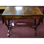 A mahogany sofa table, with a pair of drop flaps and two small drawers, on outswept legs joined by