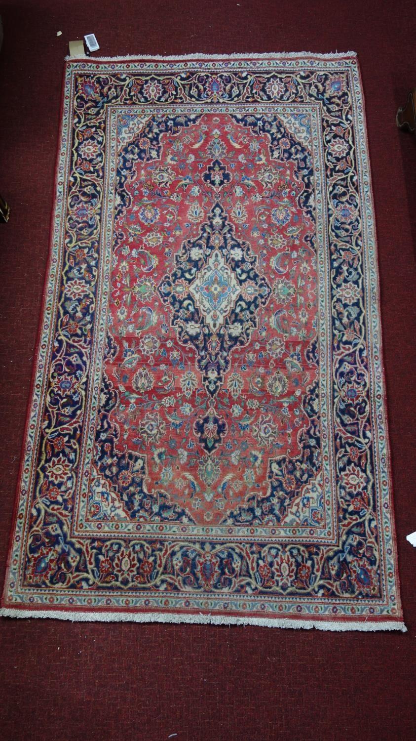 A Central Persian Kashan rug, central double pendant medallion with repeating petal motifs on a