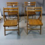 A set of four mid century teak folding chairs