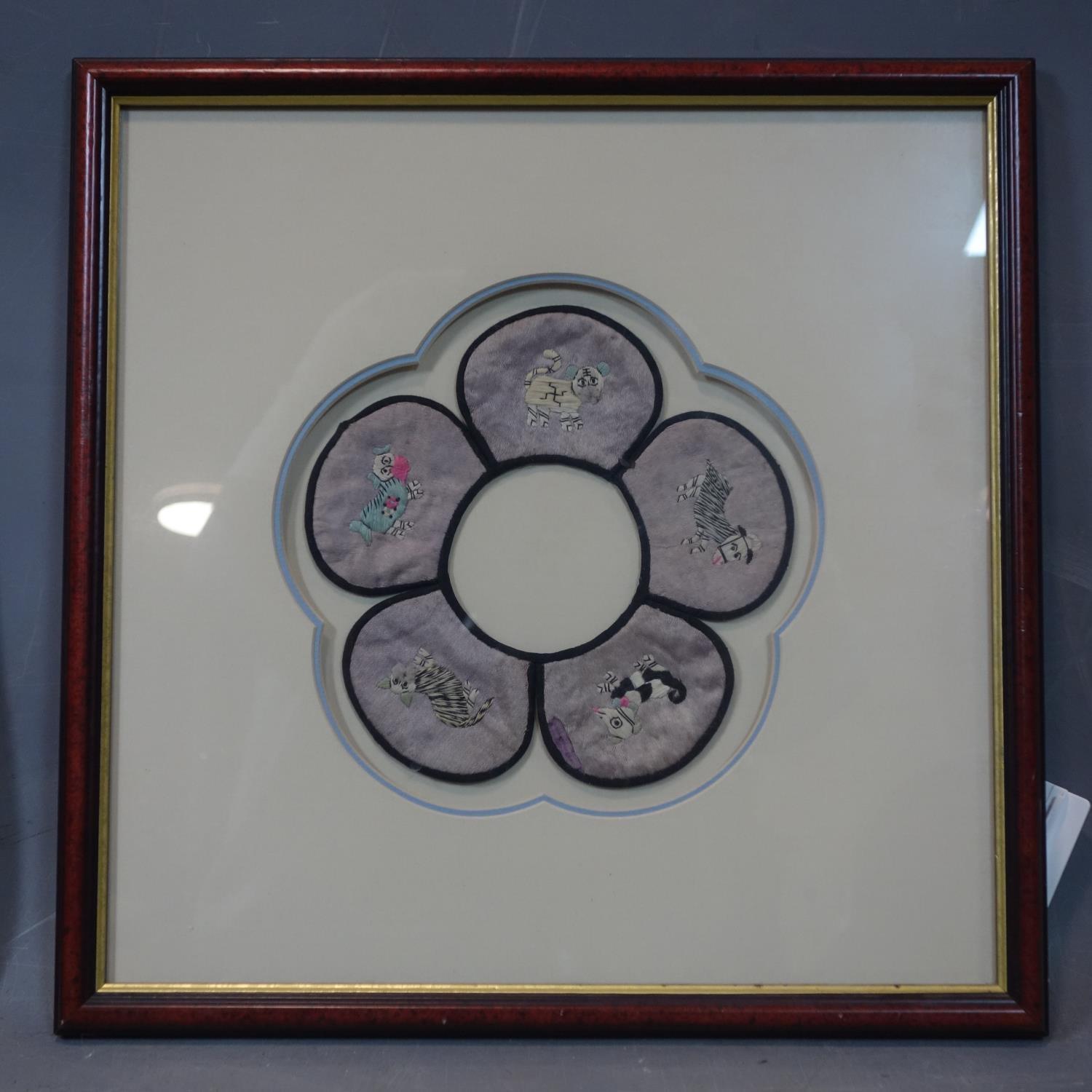 A Chinese embroidered silk Childs Collar, five petal shape with animal design, framed and glazed. - Image 2 of 2