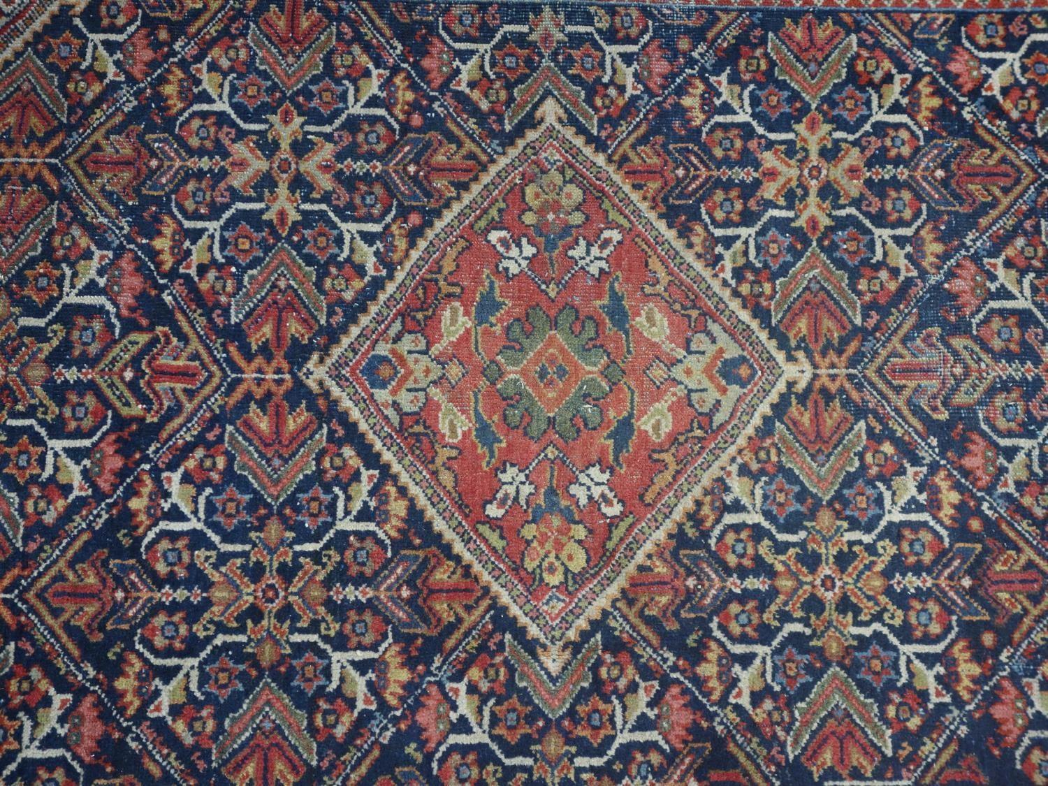 A Persian Qashqai rug, central diamond medallion and floral motifs on a dark blue ground, within - Image 2 of 5