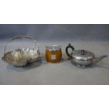 A group of silver plate items including a tea pot, a fruit basket and an ice bucket