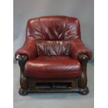 A 20th century carved mahogany and red leatherette armchair, H.93 W.93cm