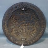 An antique iron shield relief decorated with Romanesque scenes, D.58cm