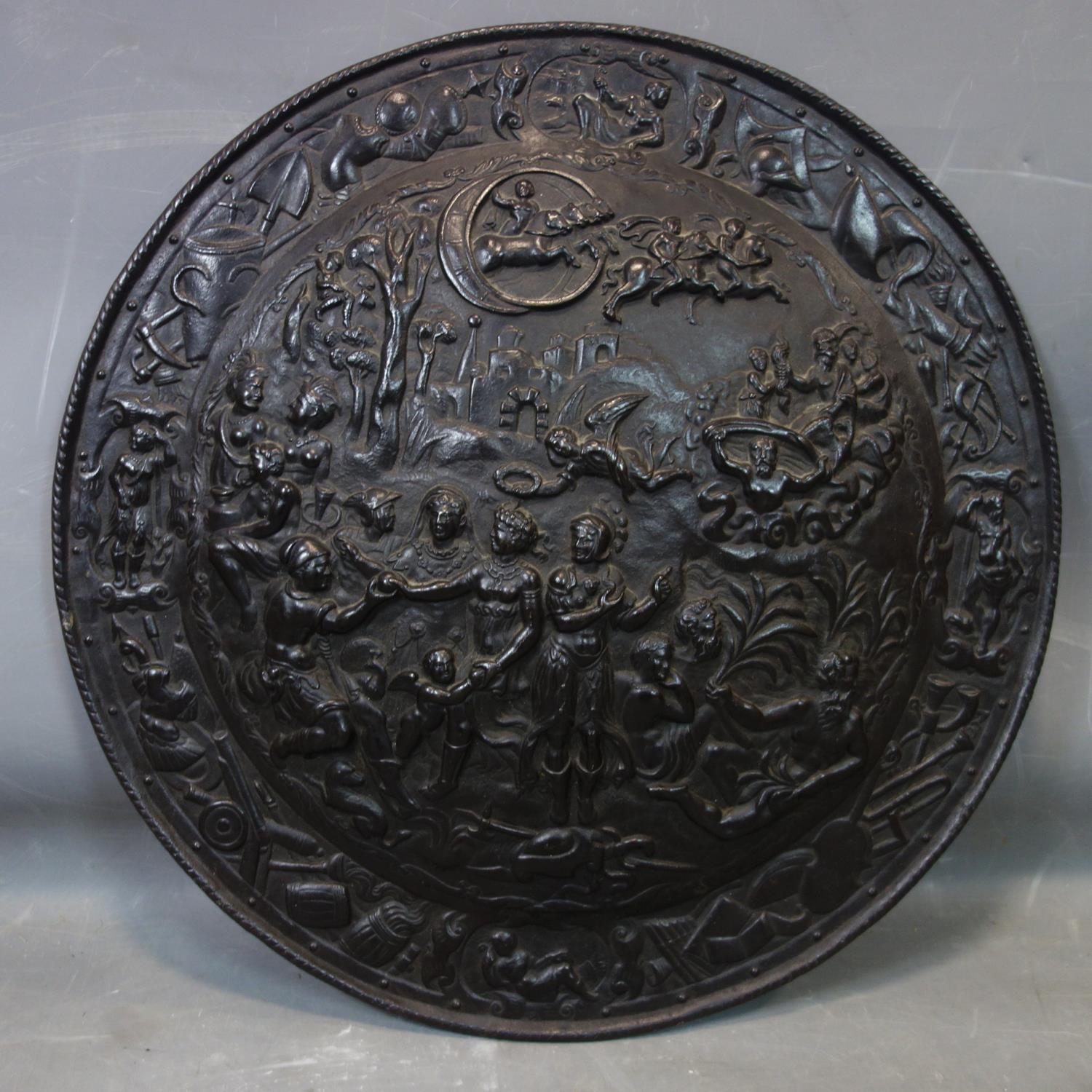 An antique iron shield relief decorated with Romanesque scenes, D.58cm - Image 2 of 3