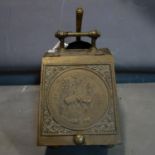 An early 20th century brass coal scuttle with shovel