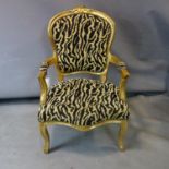 A French style gilt wood fauteuil in leopard print upholstery