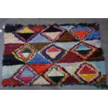 A Morrocan Berber Boucherouite rug, with multi-coloured repeating diamond design, 170 x 110cm