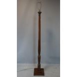 An Edwardian inlaid mahogany standard lamp, with carved floral decoration, having urn and flower