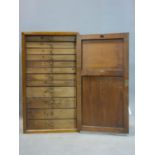 An early 20th century mahogany wall hanging collectors cabinet, with single door enclosing 12