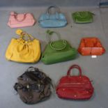 A collection of 7 Cole Haan handbags and a rucksack