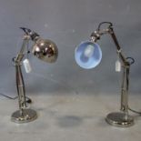 A pair of chrome angle poise lamps