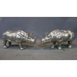 A pair of nickle rhinos, H.22 W.49 D.16cm