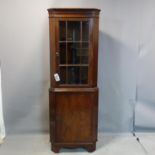 A 20th century mahogany corner cabinet, H.184 W.70 D.40cm