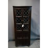 A 20th century oak corner cabinet, H.167 W.67 D.27cm