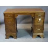 An Art Deco oak desk with six drawers, raised on bracket feet, H.71 W.98 D.44cm