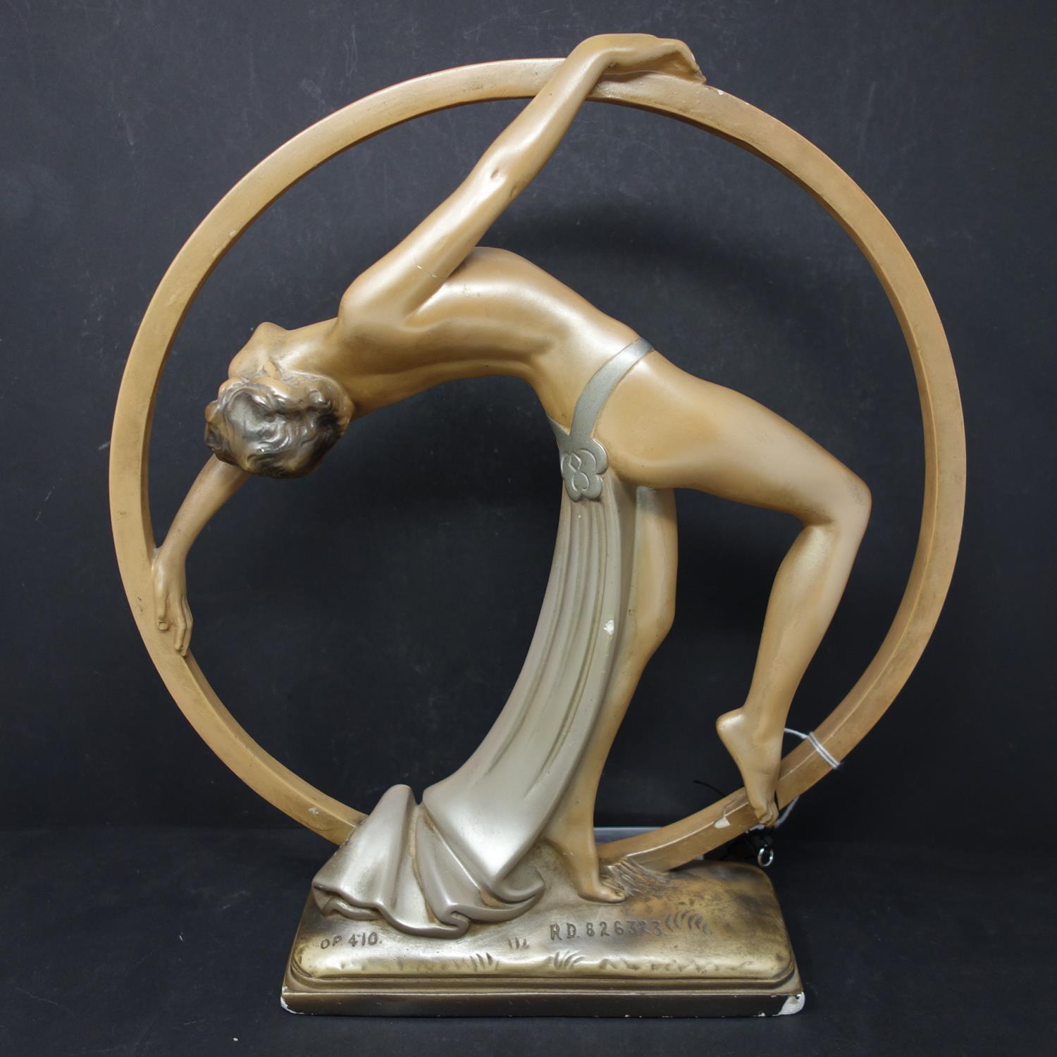 An Art Deco plaster figure of dancing girl, bearing impressed marks OP. 410, RD. 826323 to base, H.