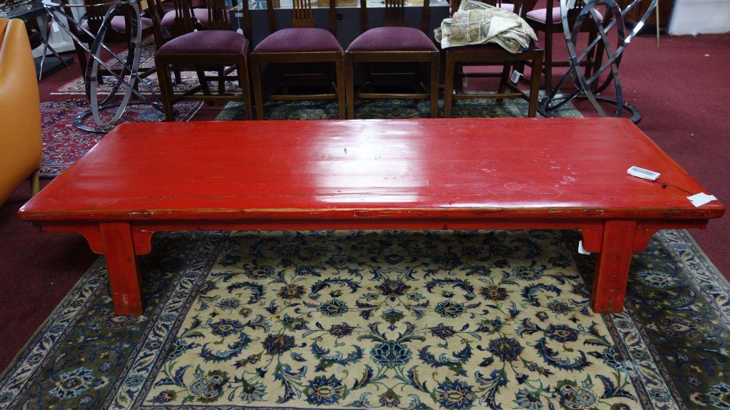 A large 20th century Chinese red lacquered coffee table, H.40 W.213 D.79cm