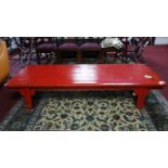 A large 20th century Chinese red lacquered coffee table, H.40 W.213 D.79cm