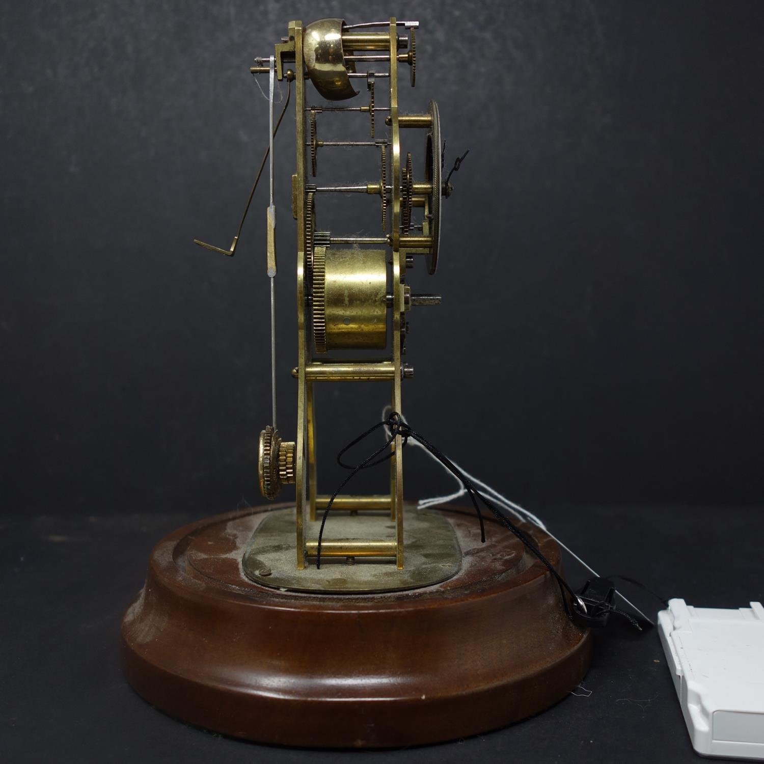 A brass skeleton clock, enamel chapter ring with Roman numerals, drum movement, on circular stand - Image 2 of 2