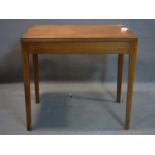 A mid 20th century teak table with leather skiver, stamped ER 1958 and with Downing street letter
