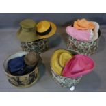 A large collection of ladies designer straw hats in 4 hat boxes