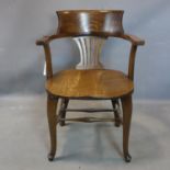 An early 20th century oak captains desk chair