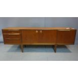A 20th century Mcintosh teak sideboard raised on tapered legs, bearing makers label, H.75 W.214 D.