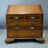 An early 20th century mahogany apprentice piece bureau, the hinged lid revealing an arrangement of