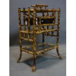 A Victorian bamboo Canterbury with Japanese lacquered panels, H.76 W.54 D.36cm