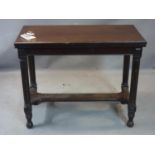 An early 20th century oak folding games table, with swivel top having red leather interior and