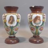 A pair of late Victorian Bohemian opaque glass vases with hand painted vignettes of ladies and