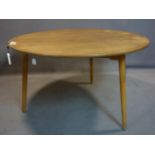 A 20th century circular teak dining table raised on 3 tapered legs, H.70 D.120cm