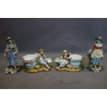 A pair of Meissen style porcelain figures together with a pair of Meissen style figural plant