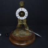 A brass skeleton clock, enamel chapter ring with Roman numerals, drum movement, on circular stand