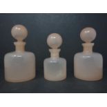 Three pink glass scent bottles of graduating size, H.16.5; H.15.5; H.14.5cm