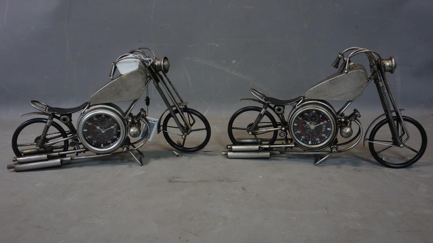 A pair of contemporary desk clocks in the form of vintage motorbikes, each having two dials with