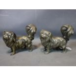 A pair of spelter Tibetan Spaniels, H.21 W.22 D.11cm