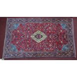 A Northwest Persian Sarouk rug, central double pendant medallion with repeating petal motifs on a