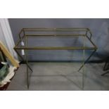 A Maison Jansen style dressing table, having glass tops, on X-shaped supports, H.88 W.95 D.42cm